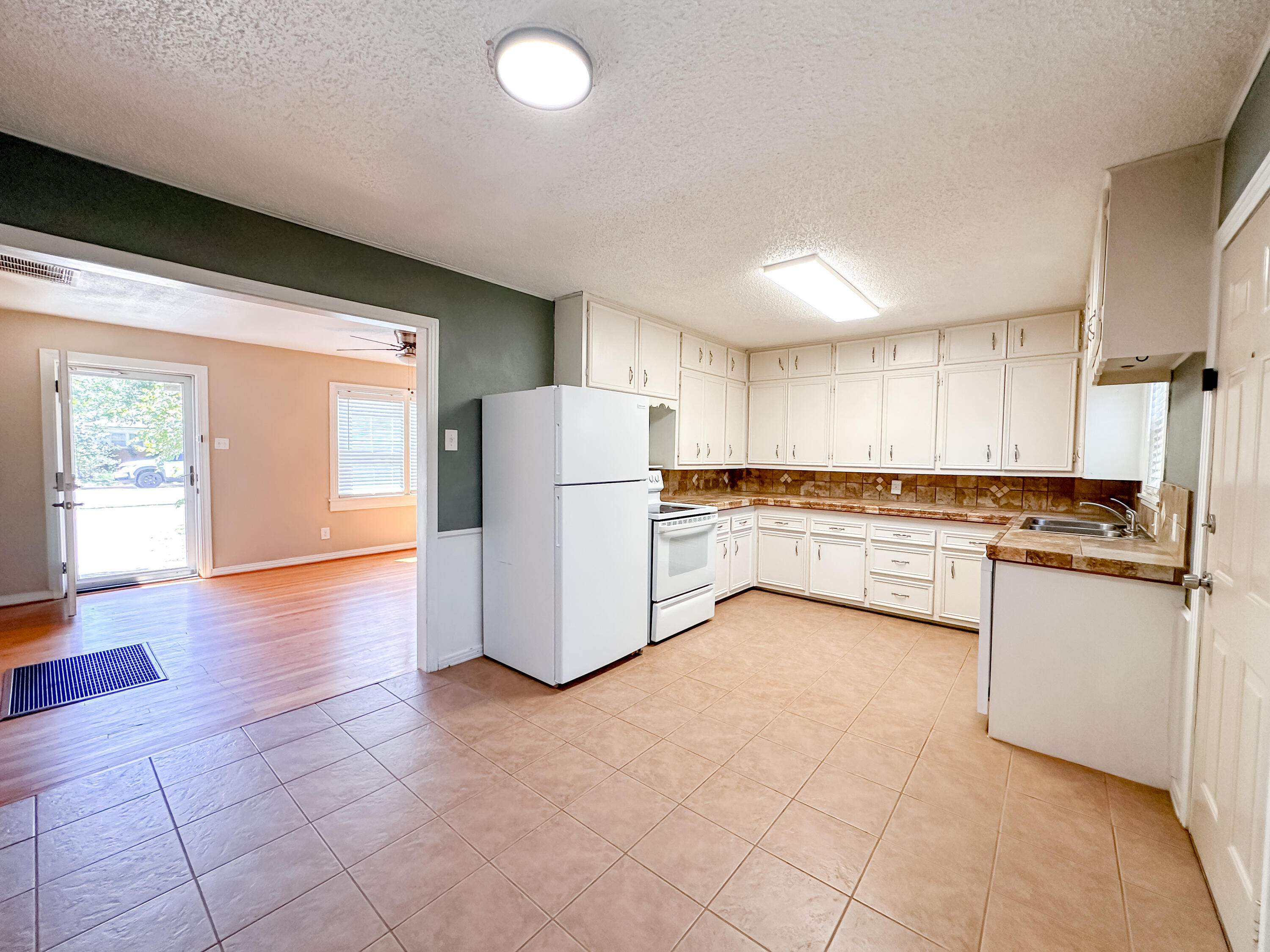 3714 26th Street Lubbock, TX 79410 - Photo 5 of 18 a kitchen with a refrigerator sink and cabinets