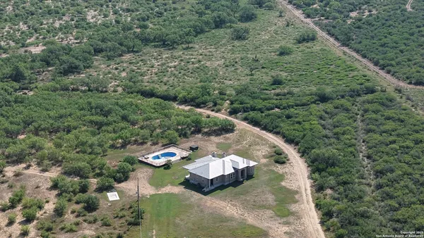 an aerial view of a house with a yard