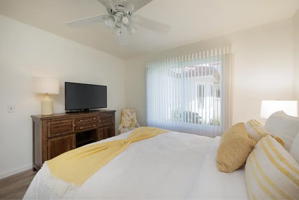 a bedroom with a bed and a flat screen tv