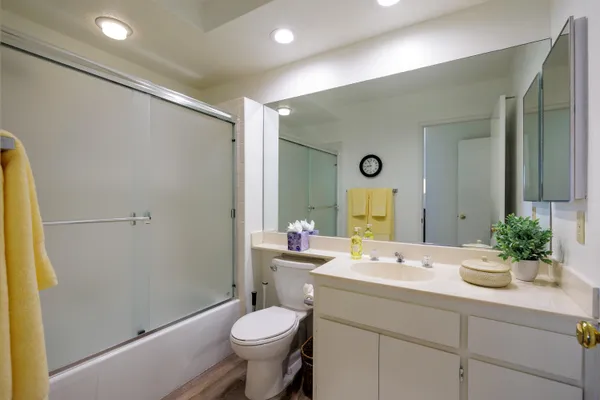 a bathroom with a double vanity sink mirror and toilet