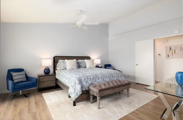 a bedroom with a bed and a couch