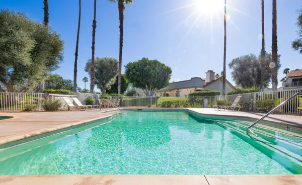 a view of an house with backyard space and lake view