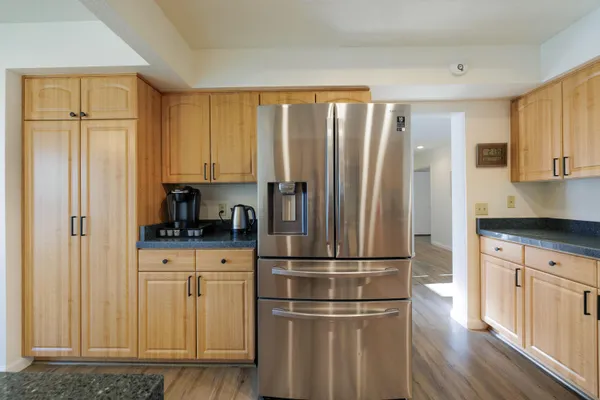 a kitchen with stainless steel appliances granite countertop a refrigerator sink and cabinets
