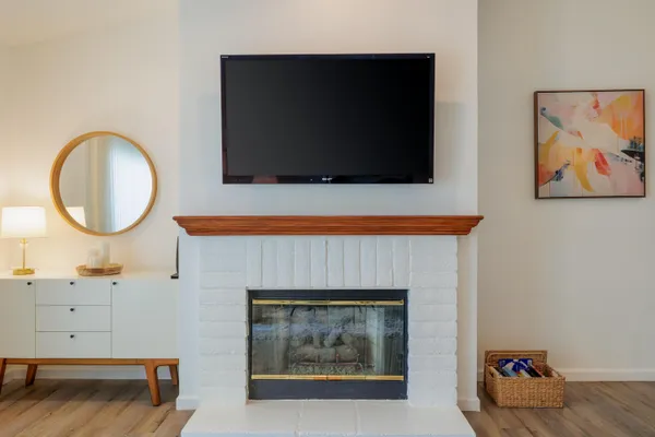 a living room with a fireplace and a flat screen tv
