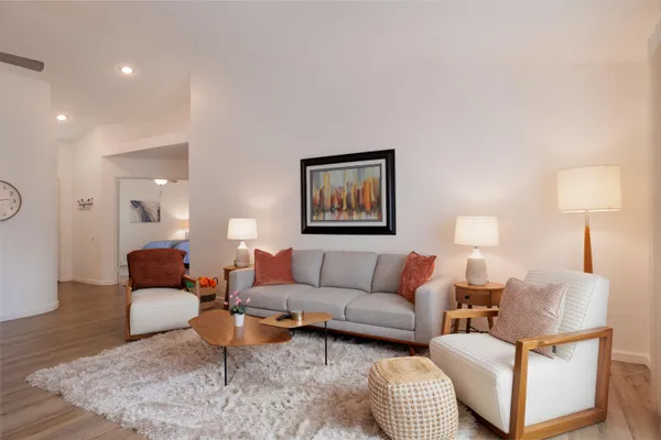 a living room with furniture and a lamp