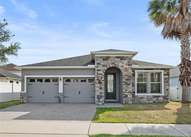 a view of a house with a swimming pool and a yard