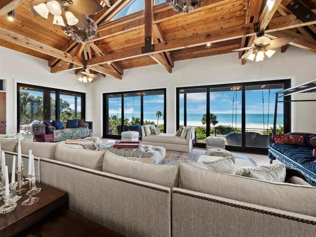 a large bedroom with a large bed a couch and a window