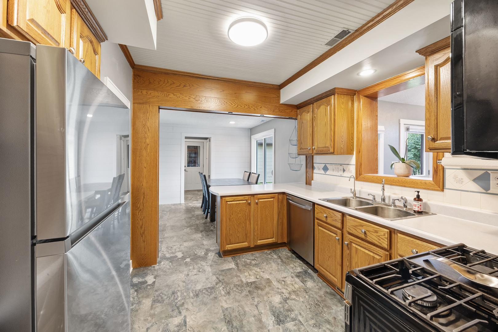 7308 West Lancaster Road Peoria, IL 61607 - Photo 12 of 55 a kitchen with a sink and a stove top oven
