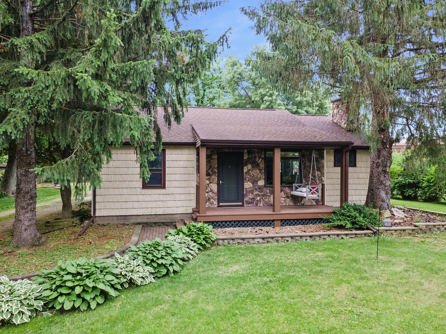 7308 West Lancaster Road Peoria, IL 61607 - Photo 2 of 55 a front view of a house with a yard table and chairs
