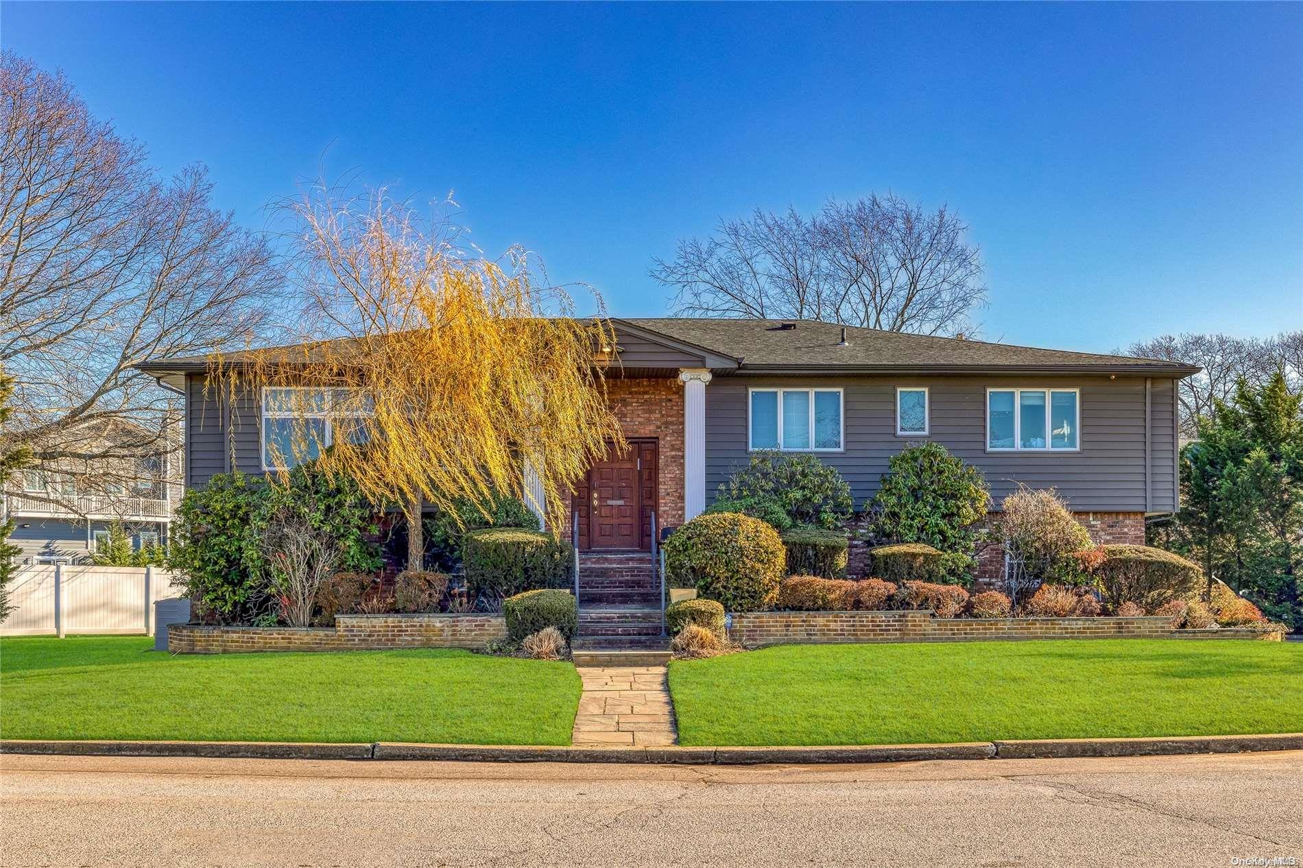 77 Bayberry Road Lawrence, NY 11559 - Photo 1 of 1 a front view of house with yard and green space
