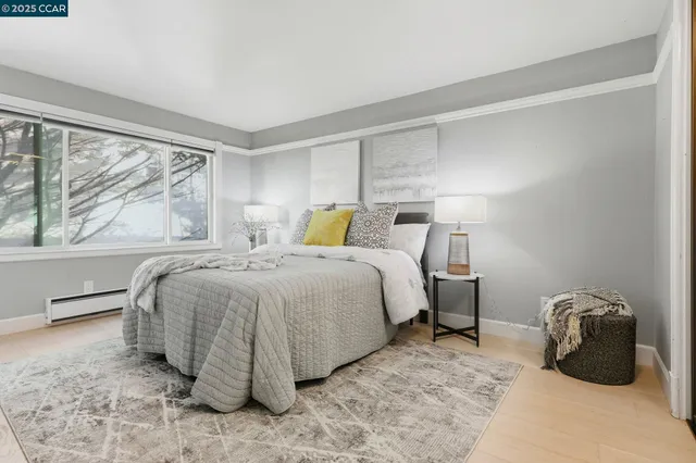 a bedroom with a bed and a large window