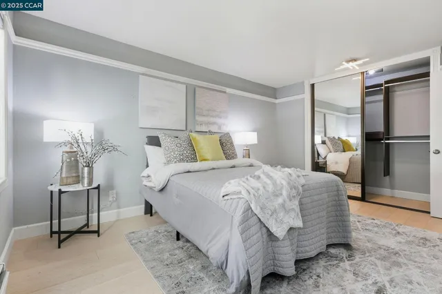 a bedroom with a bed and a chair in it