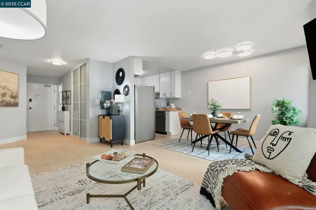 a living room with furniture and kitchen view