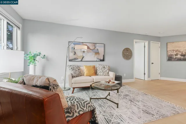 a living room with a couch and potted plant