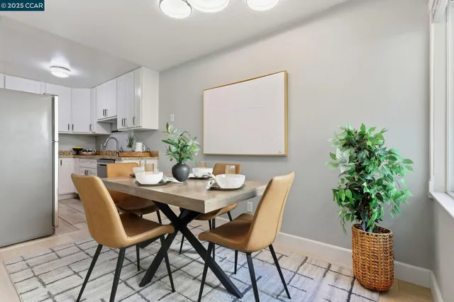 a view of a dining room with furniture and a potted plant