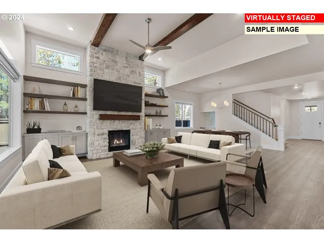 a living room with furniture a flat screen tv and a fireplace