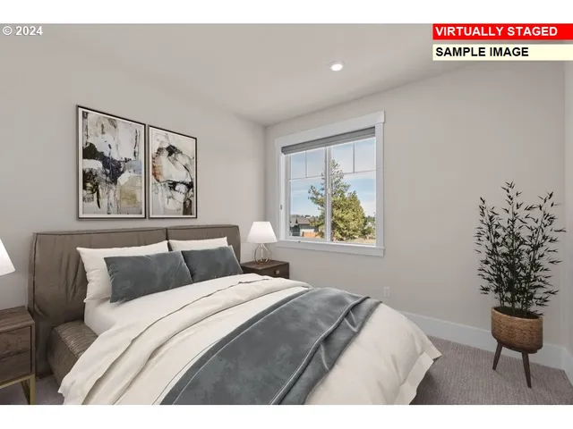 a bedroom with a bed and a painting on the wall