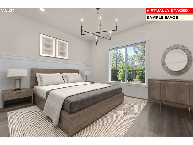 a bedroom with a large bed and a chandelier