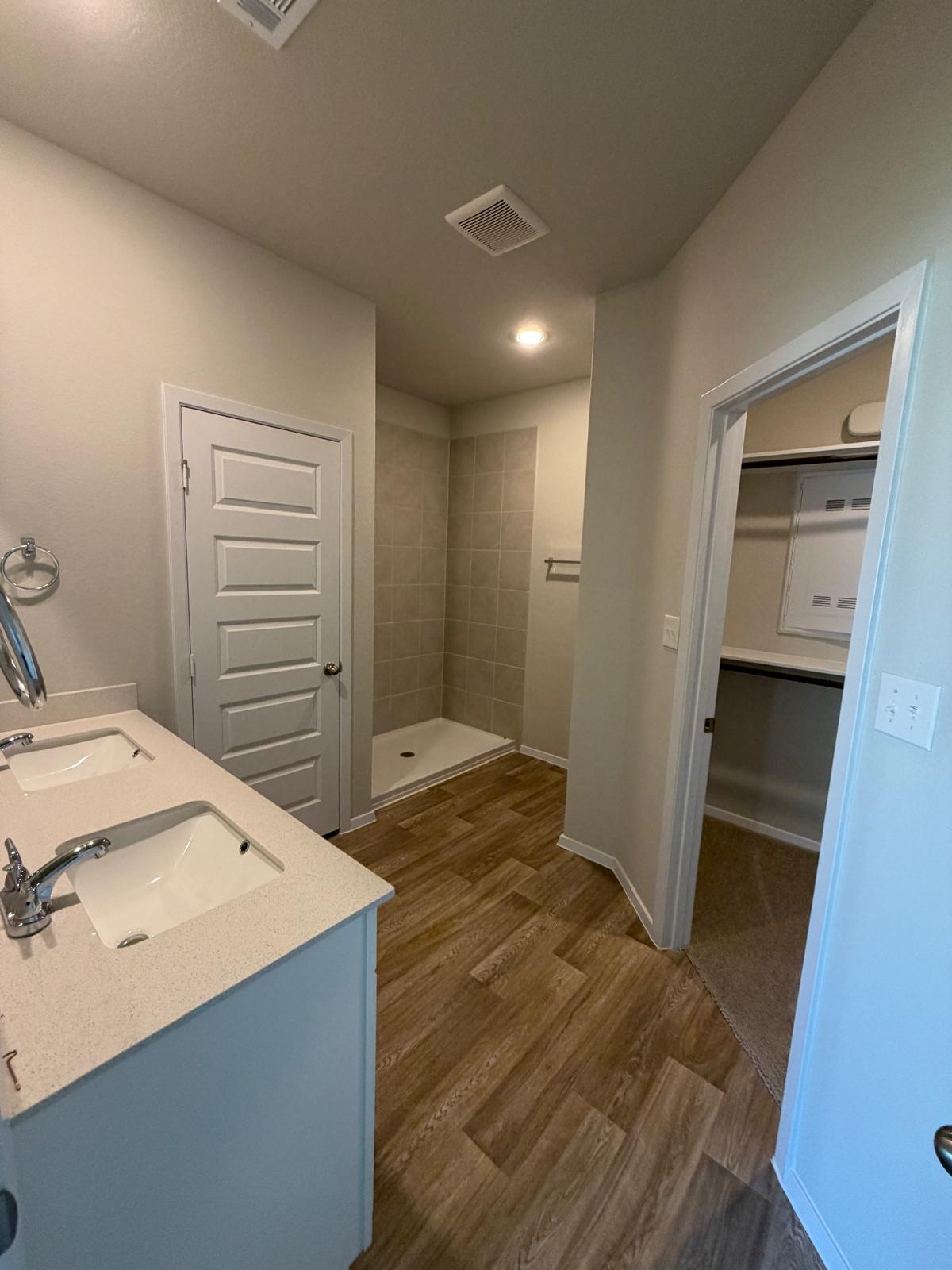 2612 Towy Road Manor, TX 78653 - Photo 19 of 35 Double vanity and a spacious shower offer functional elegance in this primary bathroom.