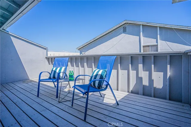 a view of sitting area in balcony with wooden floor