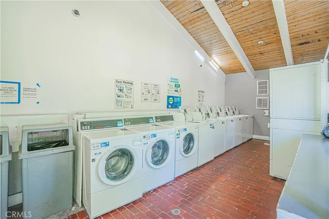 a large white kitchen with a large window