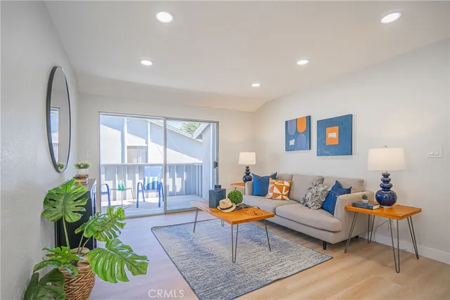 a living room with furniture a lamp and a potted plant