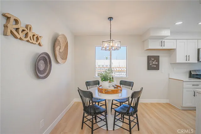 a view of a dining room with furniture and a chandelier