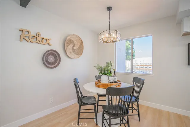 a view of a dining room with furniture wooden floor and a chandelier
