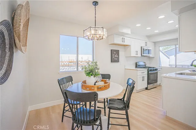 a dining room with furniture a window and wooden floor