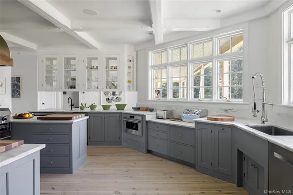 a large kitchen with a sink and cabinets