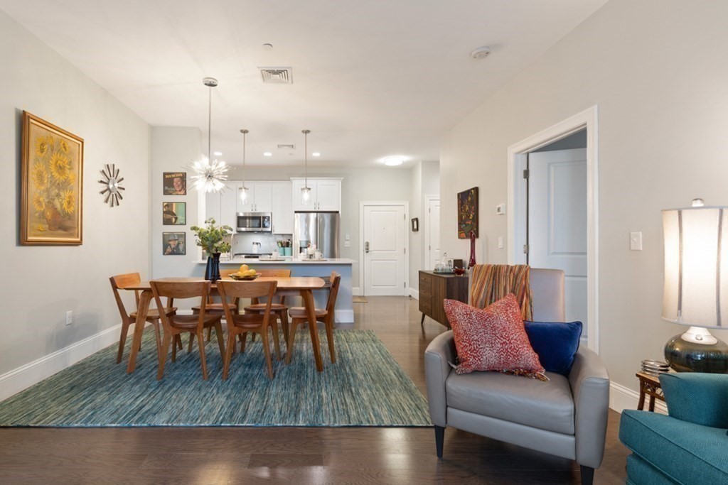 8 Sanborn Street, Unit 1009 Reading, MA 01867 - Photo 14 of 30 a living room with furniture and kitchen view