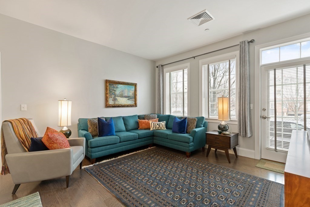 8 Sanborn Street, Unit 1009 Reading, MA 01867 - Photo 16 of 30 a living room with furniture and a rug