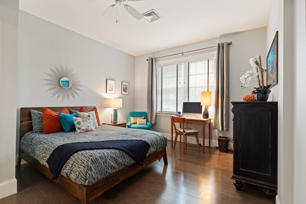 8 Sanborn Street, Unit 1009 Reading, MA 01867 - Photo 17 of 30 a bedroom with a bed and wooden floor