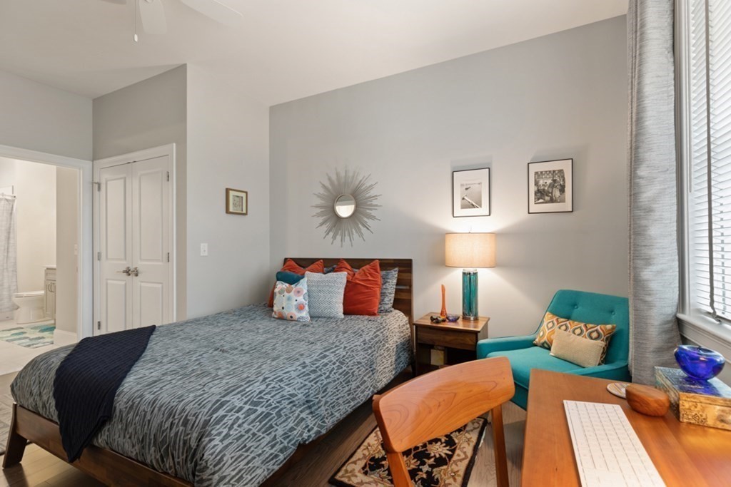 8 Sanborn Street, Unit 1009 Reading, MA 01867 - Photo 18 of 30 a bedroom with a bed and wooden floor