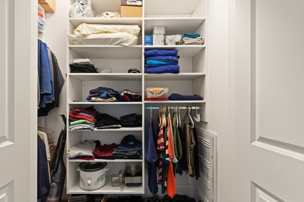 8 Sanborn Street, Unit 1009 Reading, MA 01867 - Photo 20 of 30 a view of walk in closet with clothes and shoes