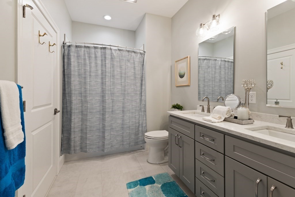 8 Sanborn Street, Unit 1009 Reading, MA 01867 - Photo 21 of 30 a bathroom with a sink a toilet and shower