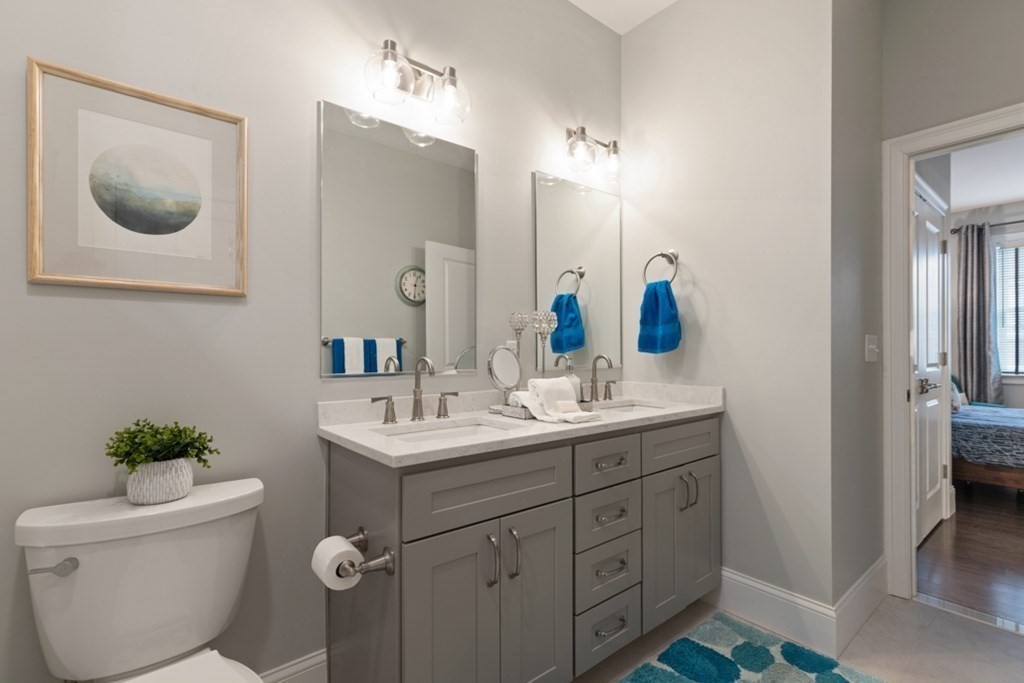 8 Sanborn Street, Unit 1009 Reading, MA 01867 - Photo 22 of 30 a bathroom with a toilet sink and mirror