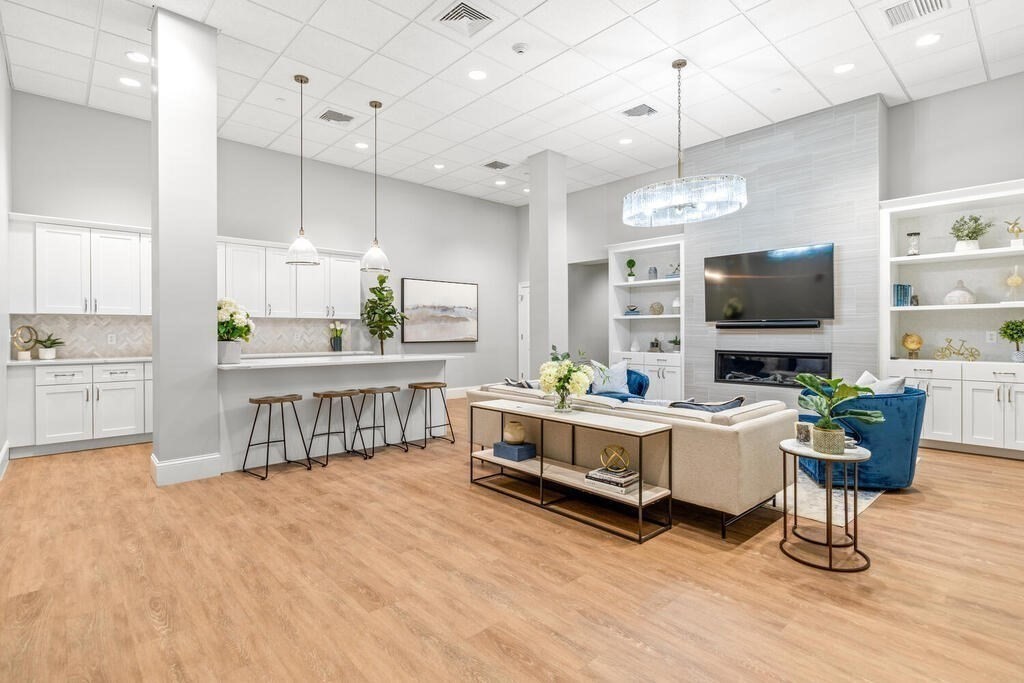 8 Sanborn Street, Unit 1009 Reading, MA 01867 - Photo 27 of 30 a living room with furniture flat screen tv and kitchen view