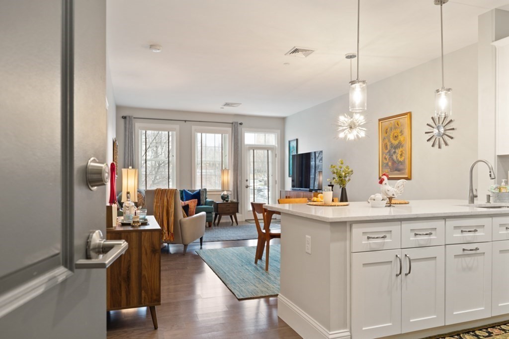 8 Sanborn Street, Unit 1009 Reading, MA 01867 - Photo 4 of 30 a view of living room with granite countertop furniture and a wooden floor