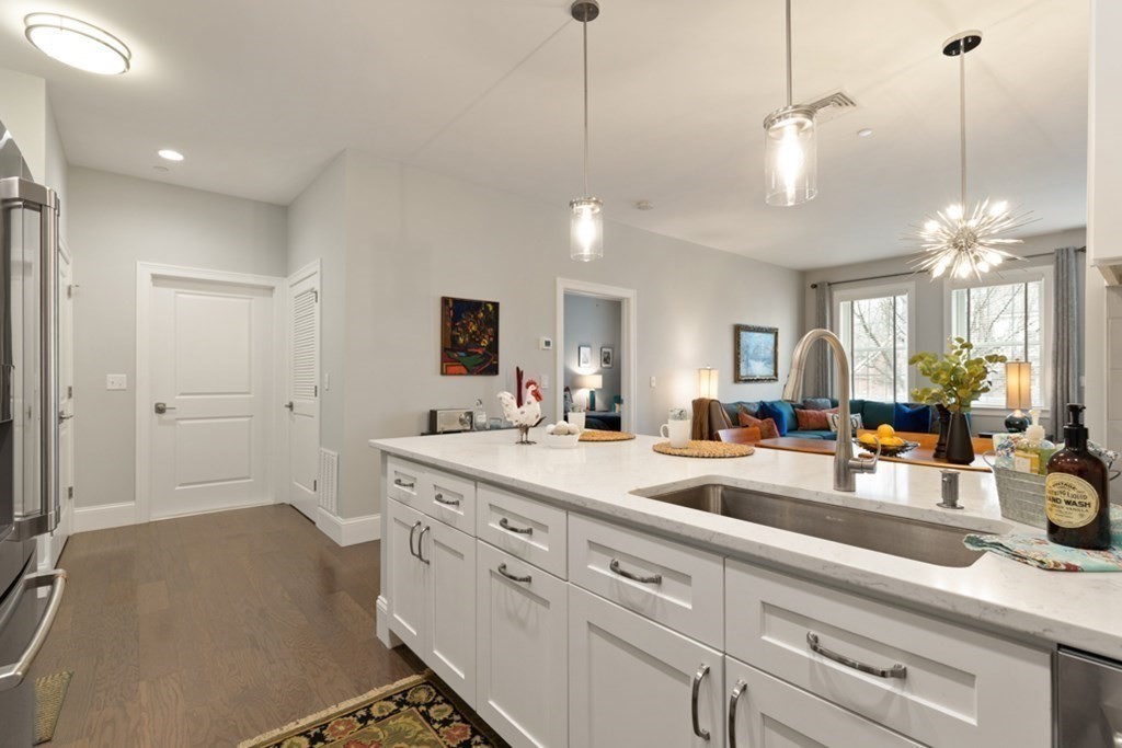 8 Sanborn Street, Unit 1009 Reading, MA 01867 - Photo 10 of 30 a view of a center island and living room with furniture