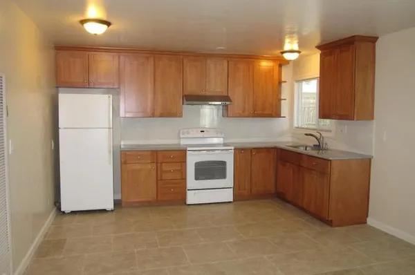 a kitchen with a stove top oven and sink