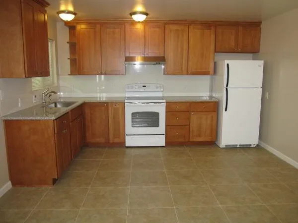 a kitchen with a stove sink and cabinets