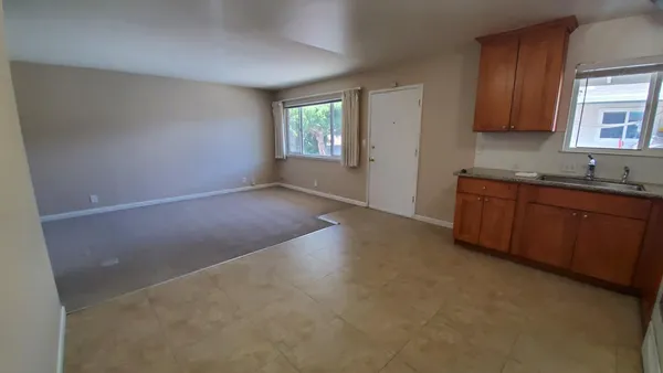 a view of a kitchen with a sink cabinet and a window