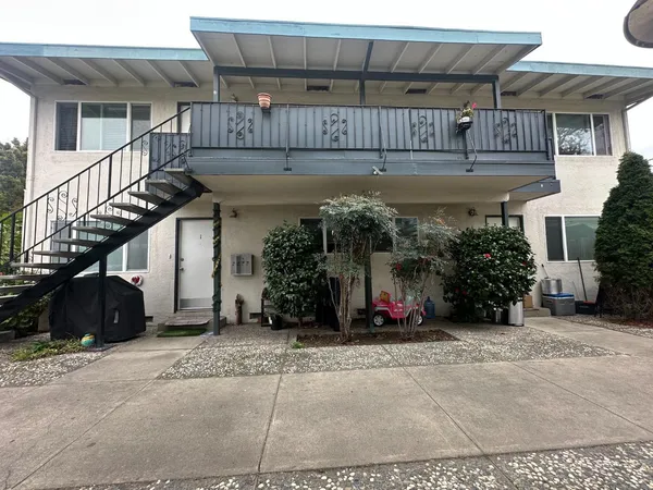 a view of a house with lots of windows and plants