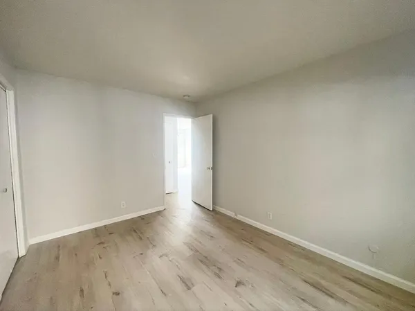 a view of an empty room and wooden floor