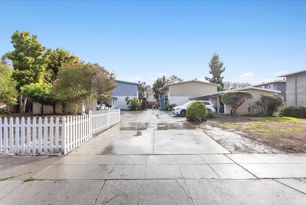 a view of a house with backyard and sitting area