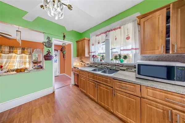 a kitchen with lots of counter top space and wooden floor