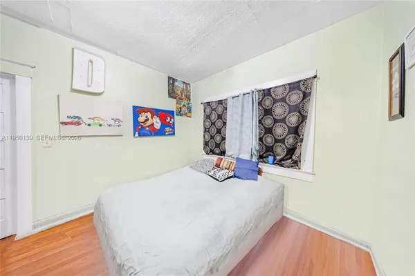 a bed room with a bed and a wall painting