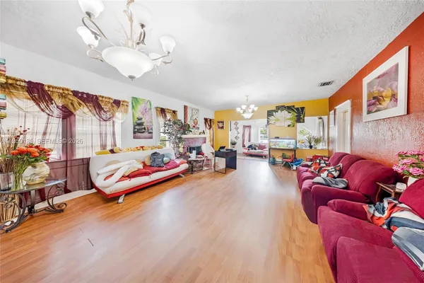 a living room with furniture and a chandelier