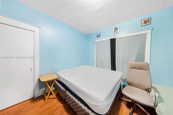 a bedroom with a bed and a table in it